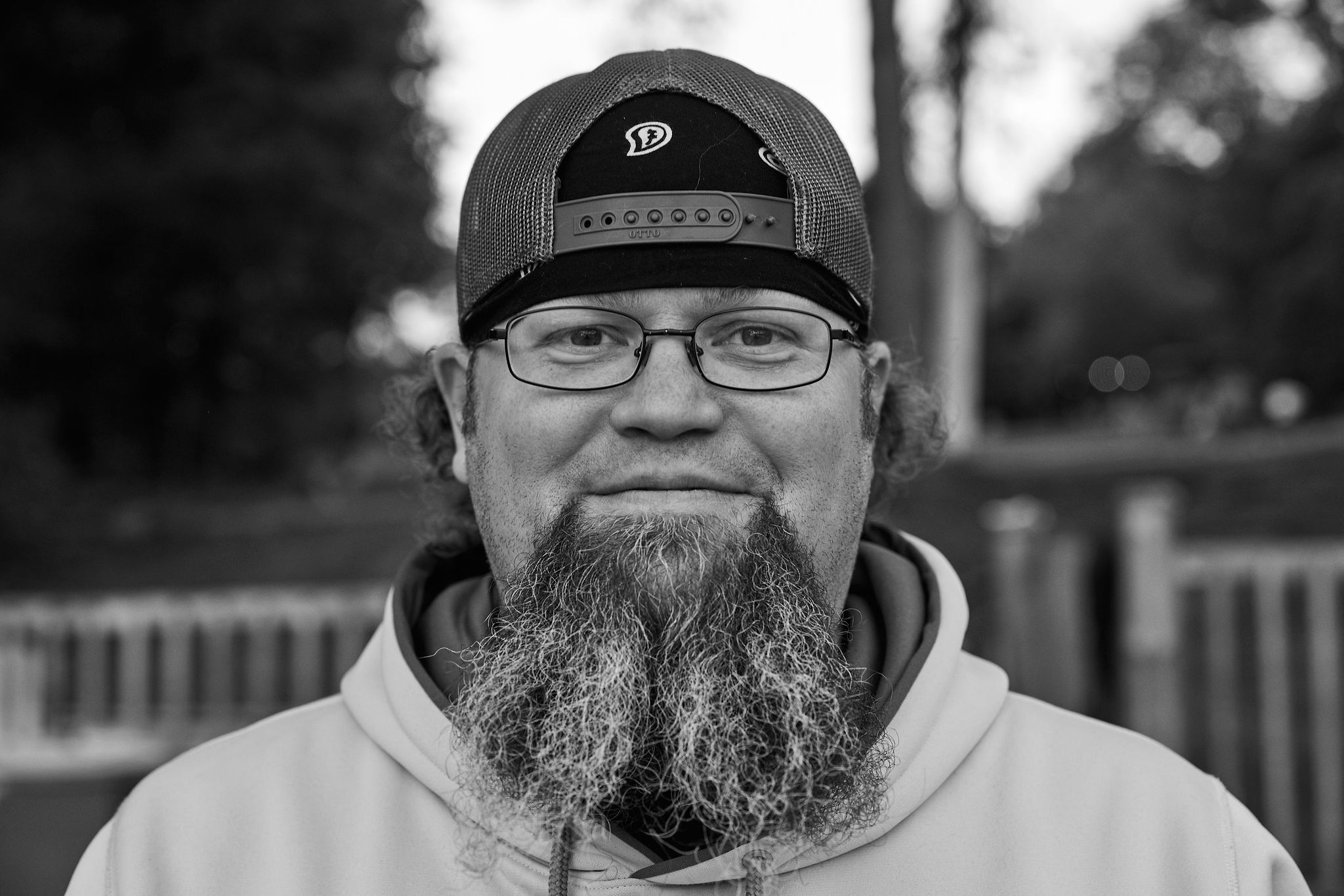 Patrick Tingley, known at camp as Tingles, Kilcoo Camp Director, in a black and white portrait wearing a Kilcoo cap.