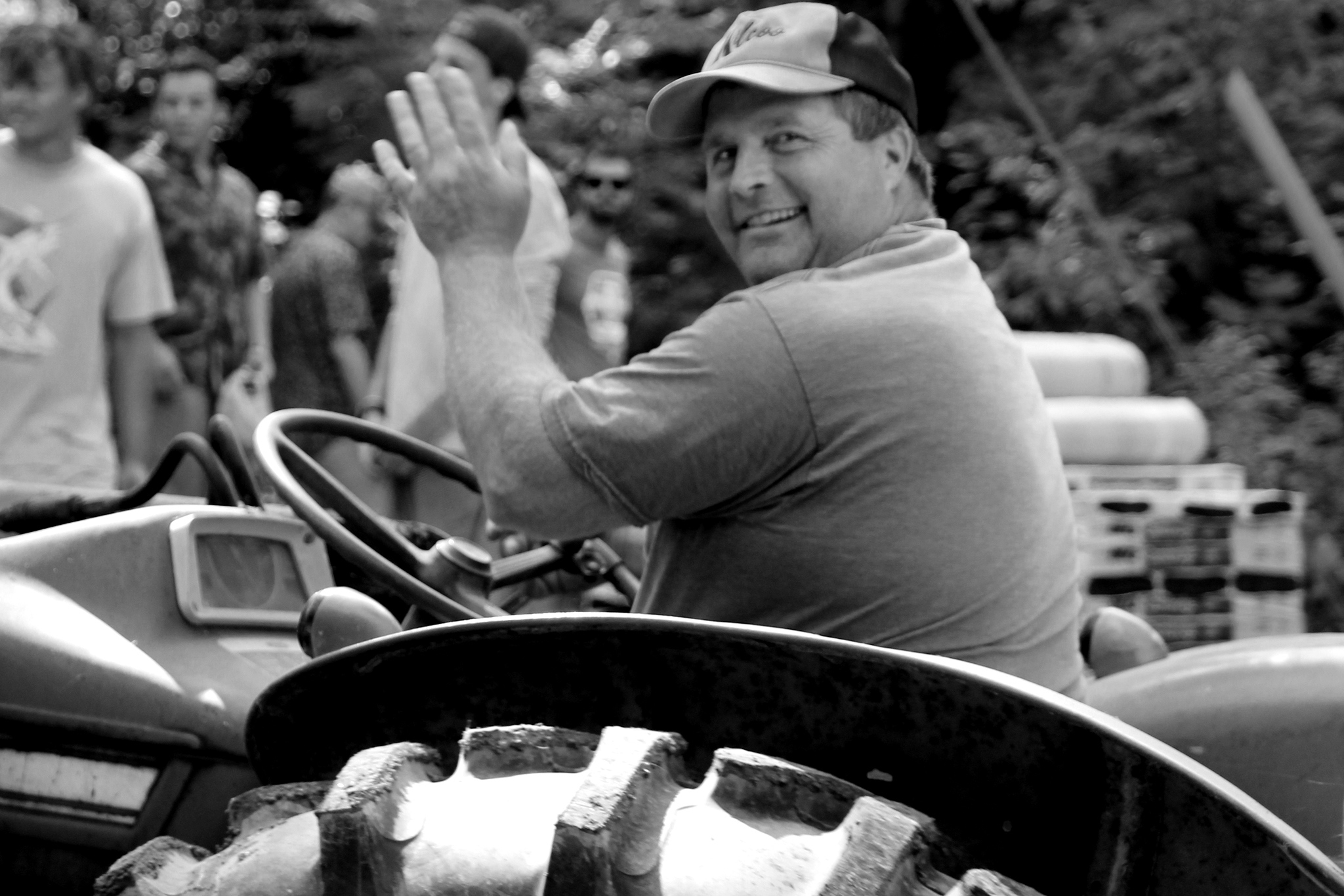 Kent Taylor, Kilcoo Property Manager, waving from the seat of a tractor at camp.