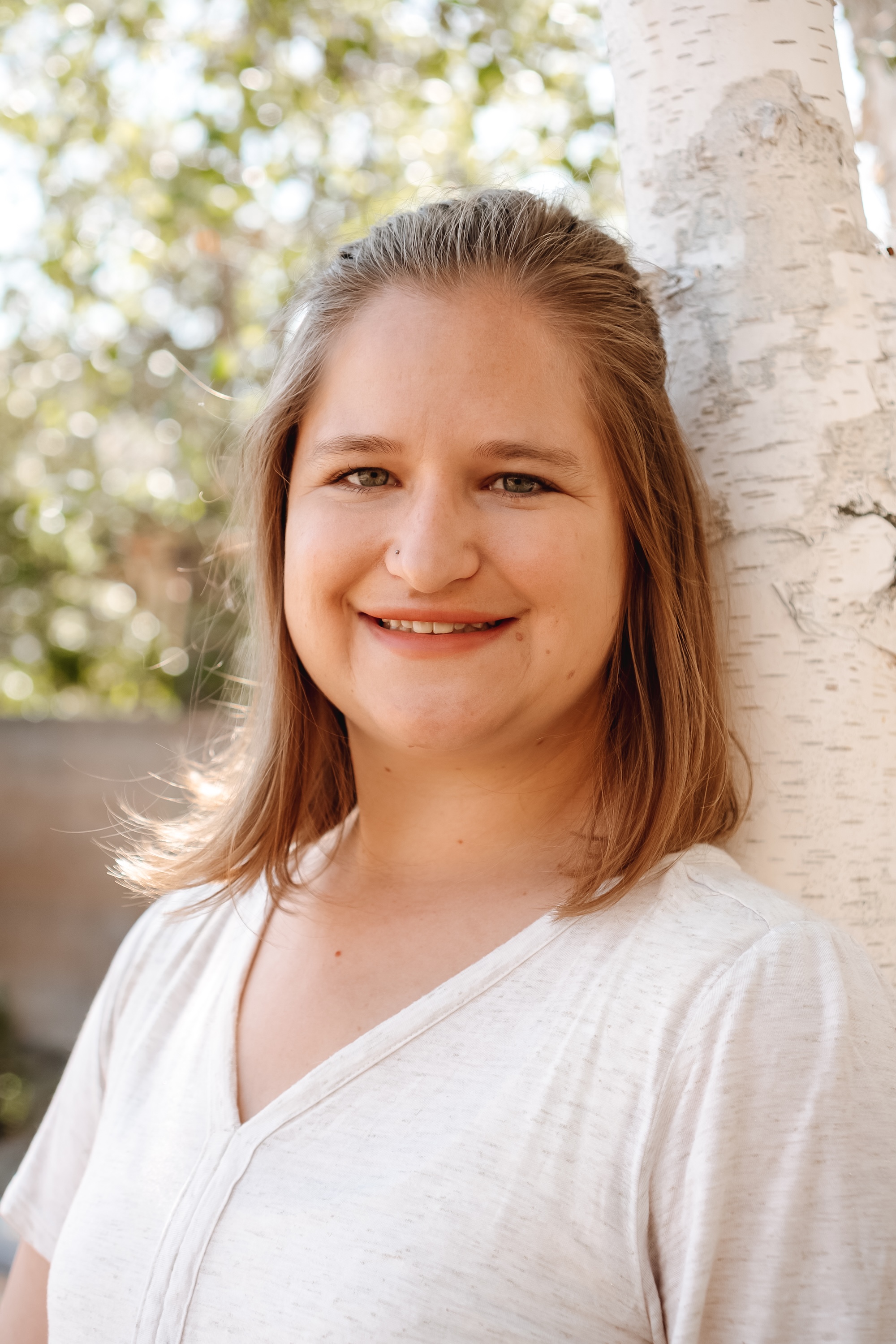 Hannah Ly, LMFT, child therapist and founder of Your Therapy Nook in San Jose and Redwood City, beside a birch tree
