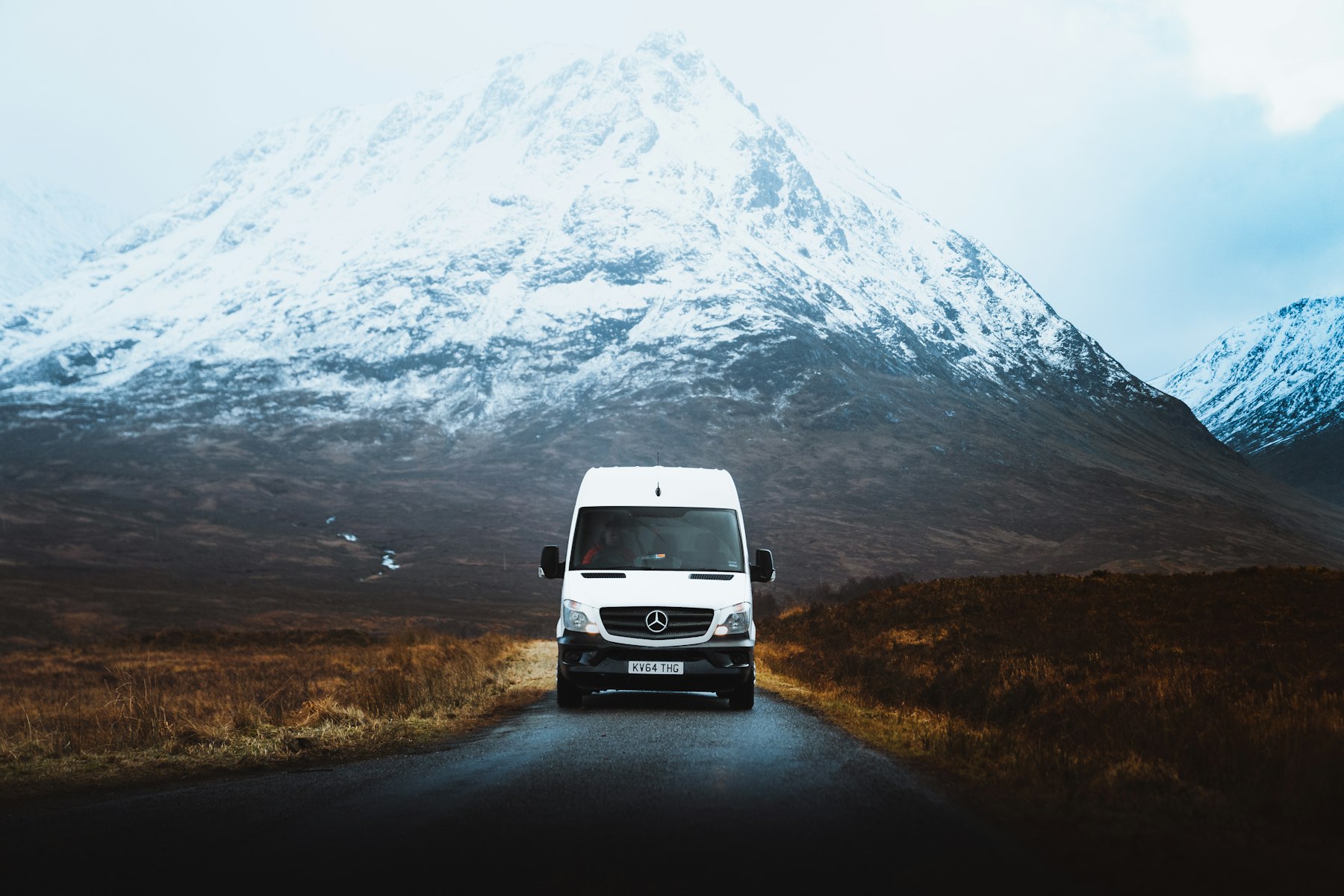 White service van driving on the road