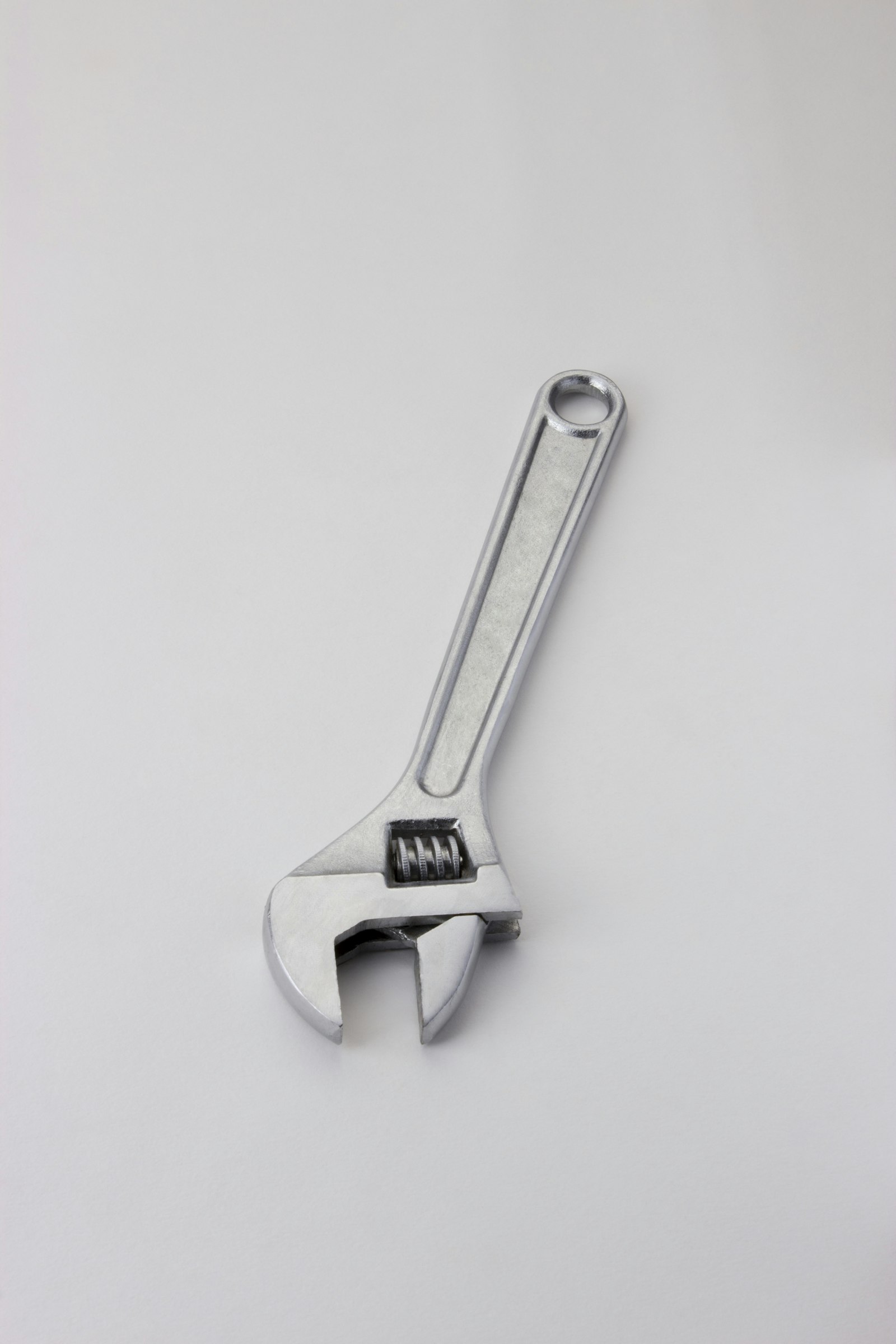 Steel adjustable wrench on a clean workbench