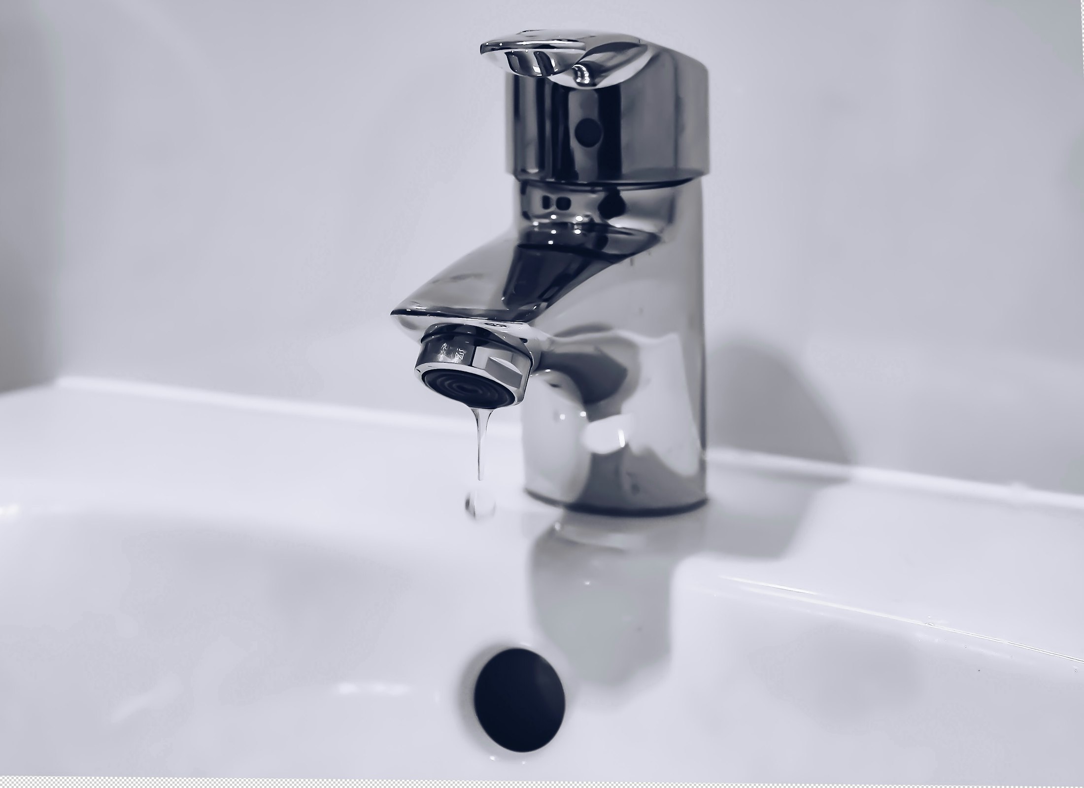 Licensed plumber repairing a pipe inside a wall