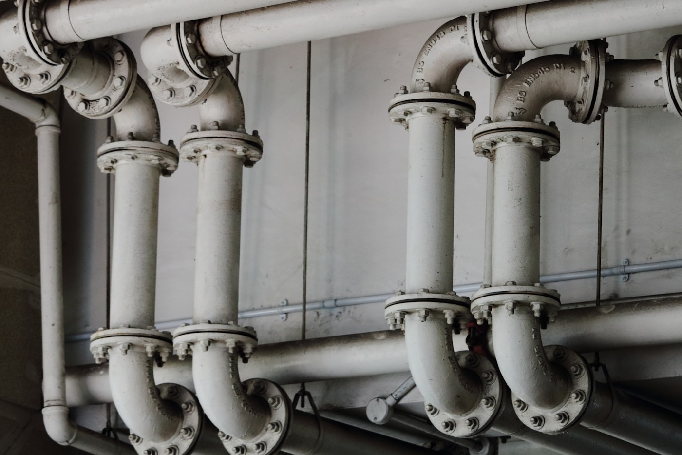 Rows of flanged supply pipes in a commercial building