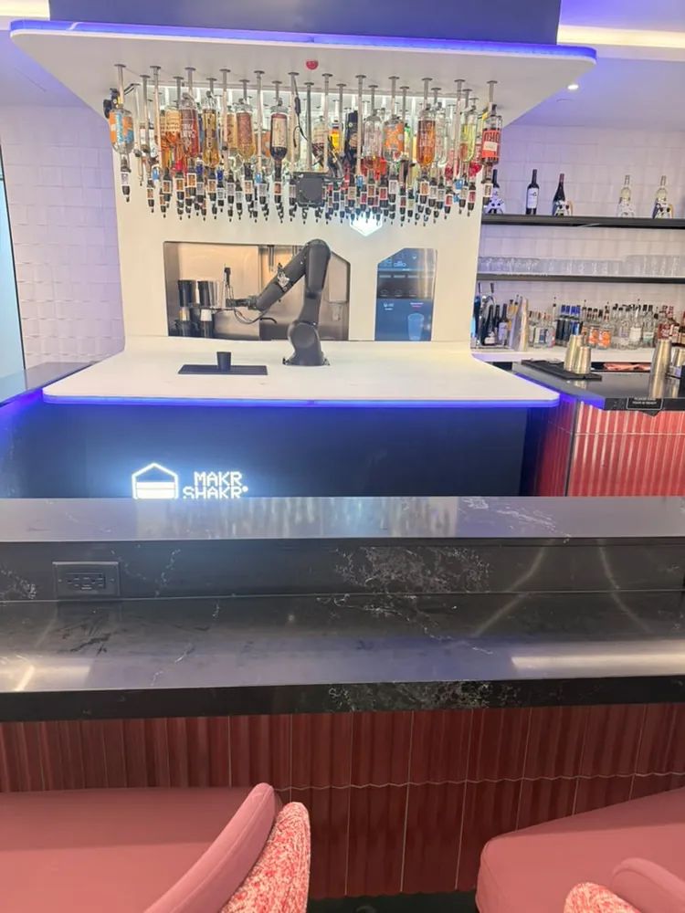 Makr Shakr robotic bar arm at Portal Lounge MSP with bottles suspended above the counter