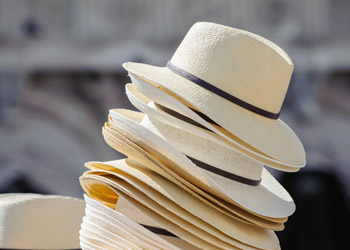 Close-fitting wrap-around sunglasses and a hat providing UV protection around reflective surfaces