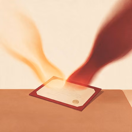 Hands reaching across a table toward a certificate with a gold seal inside a red folder.