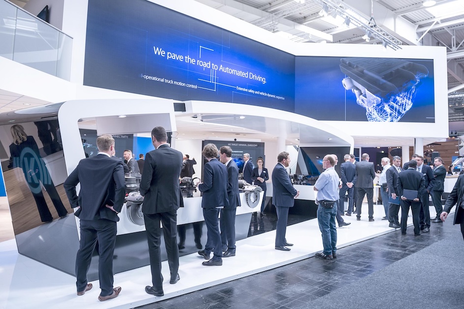 Knorr-Bremse exhibition stand with visitors and large presentation screens at IAA Commercial Vehicles 2018.