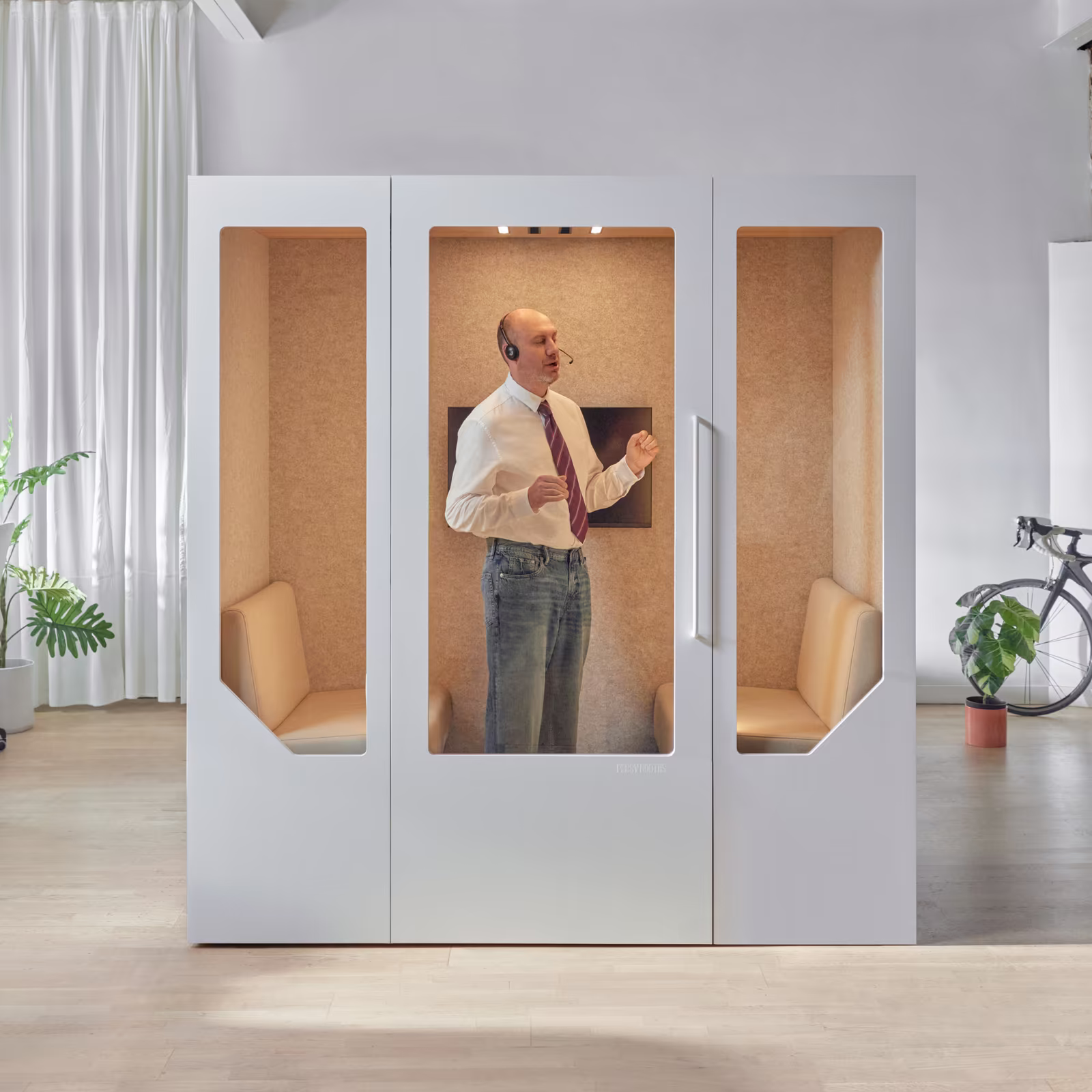 Team holding a meeting inside a soundproof office pod