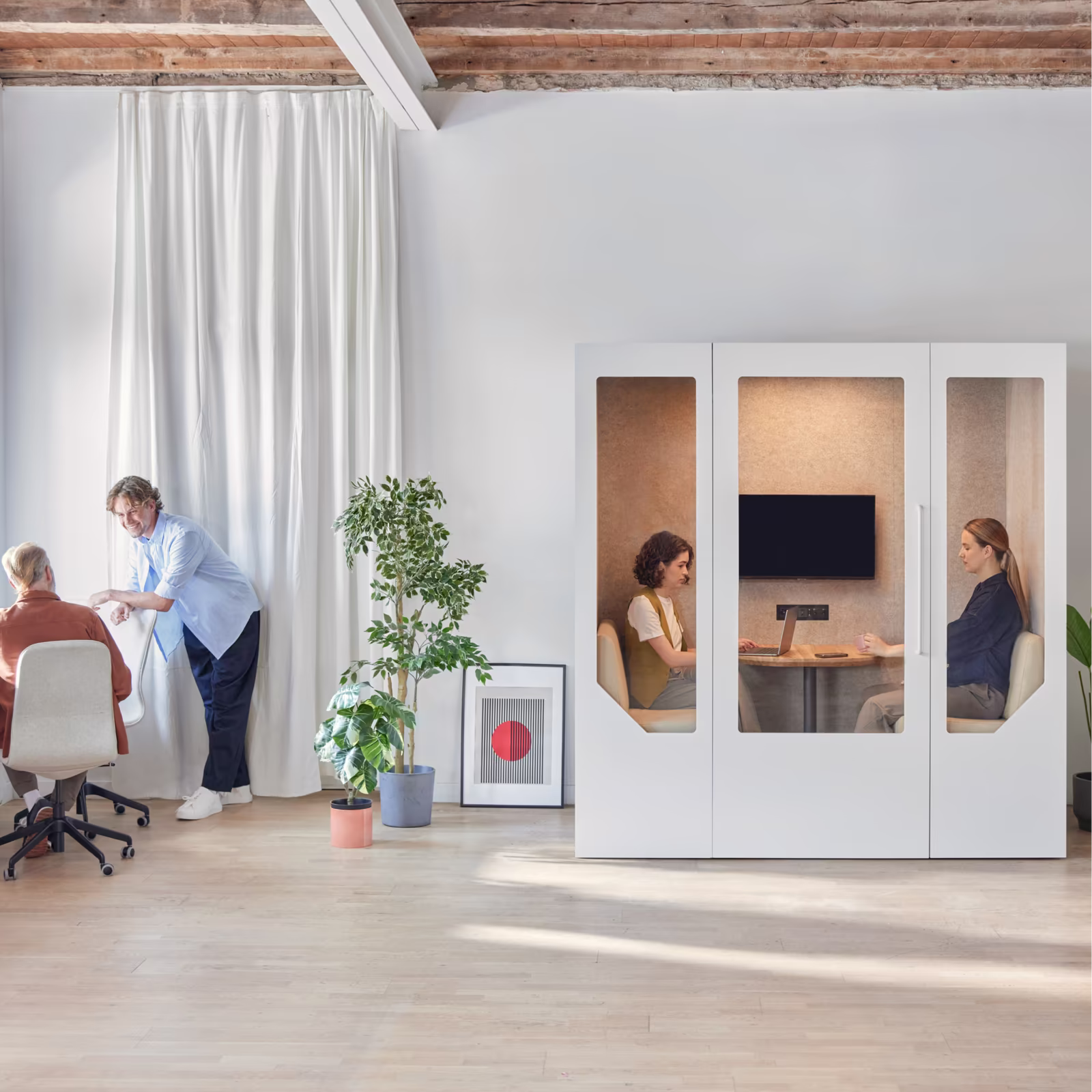 Acoustic office pods integrated into a modern open-plan workspace with employees working and collaborating