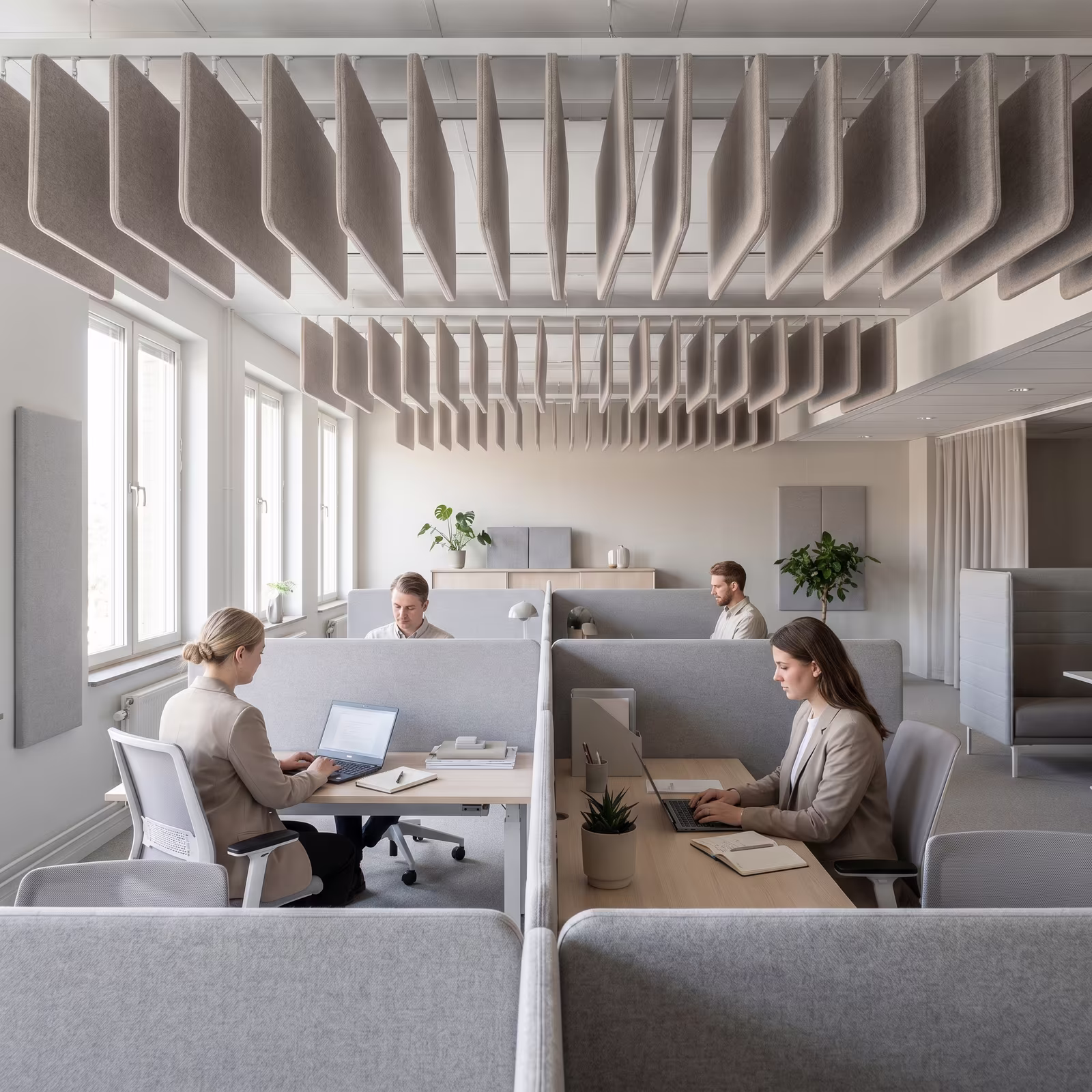 Employees working in an acoustically treated open-plan office workspace