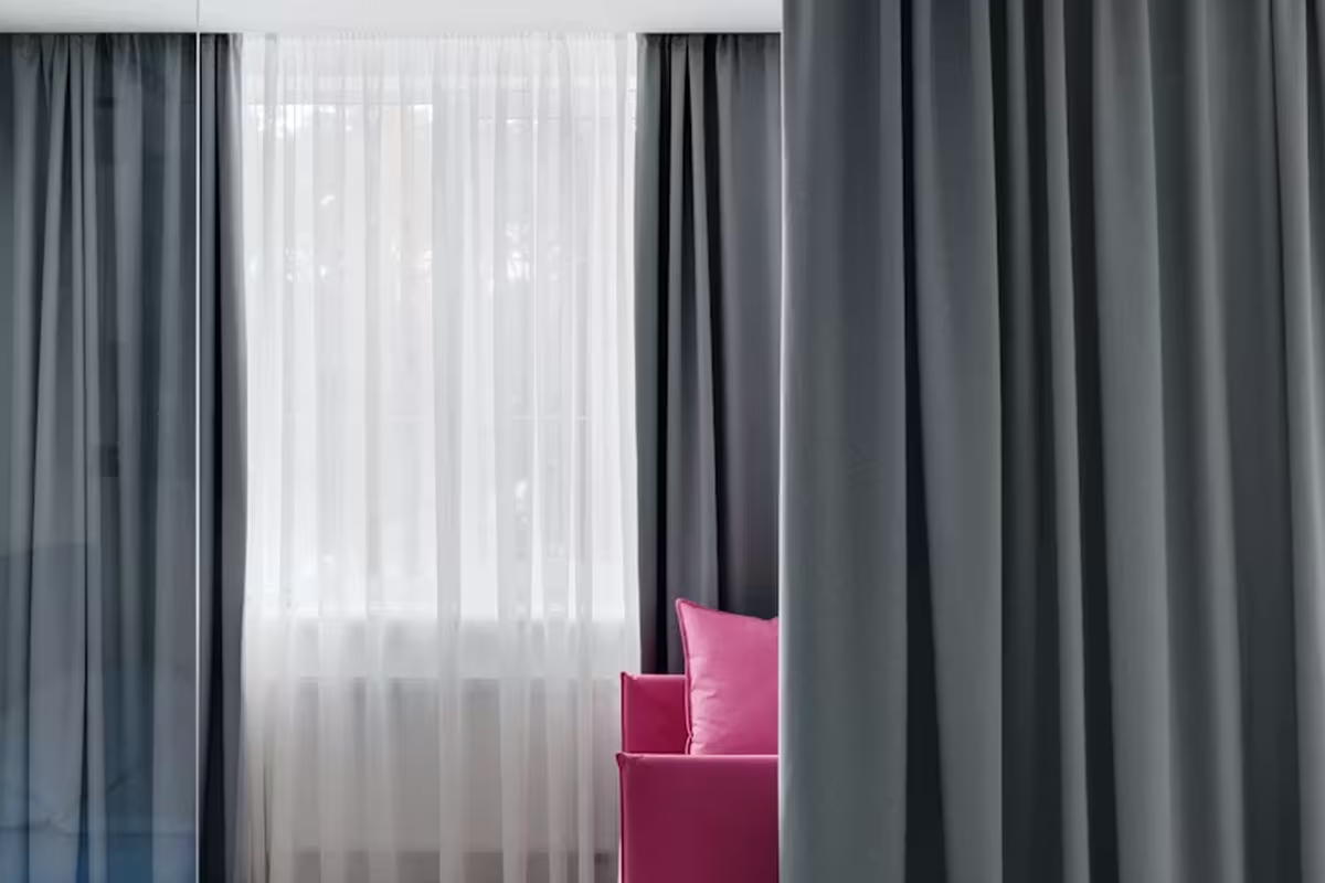 Grey noise canceling curtains covering an open space room
