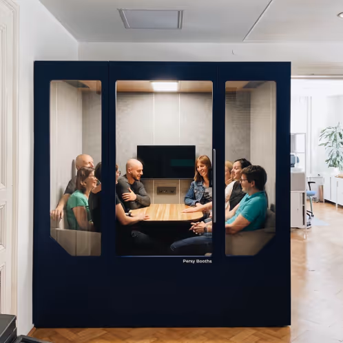 Four people having a meeting inside a large Persy office pod
