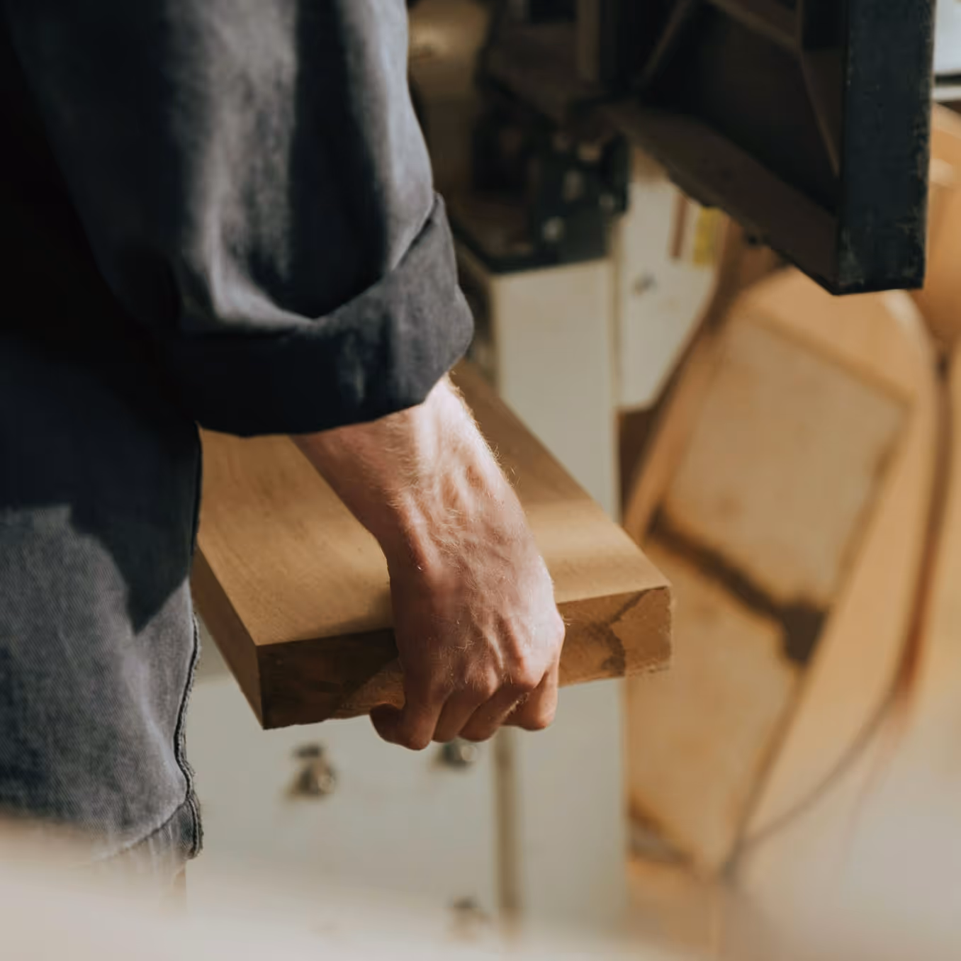 Craftsman working with high-quality wood at an EU manufacturing facility, ensuring Persy Booths meet the highest quality standards