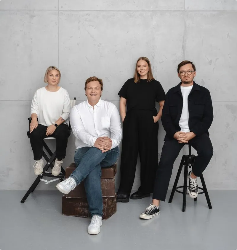 Persy Booths leadership team portrait in front of concrete wall