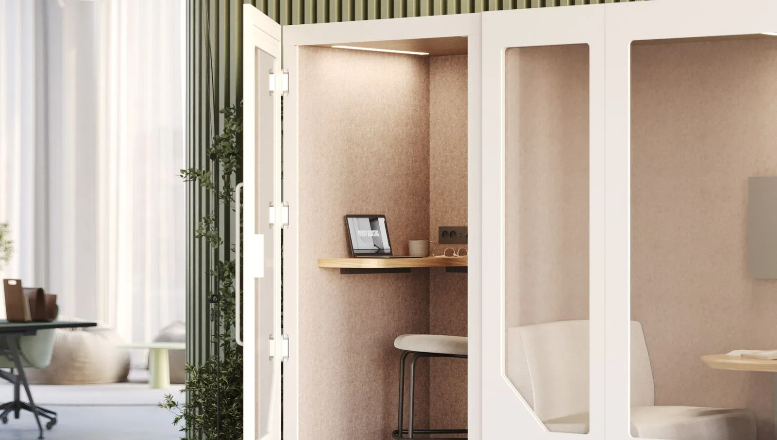 Interior of Persy Booth with desk, laptop, stool, and acoustic walls designed for private work and video calls