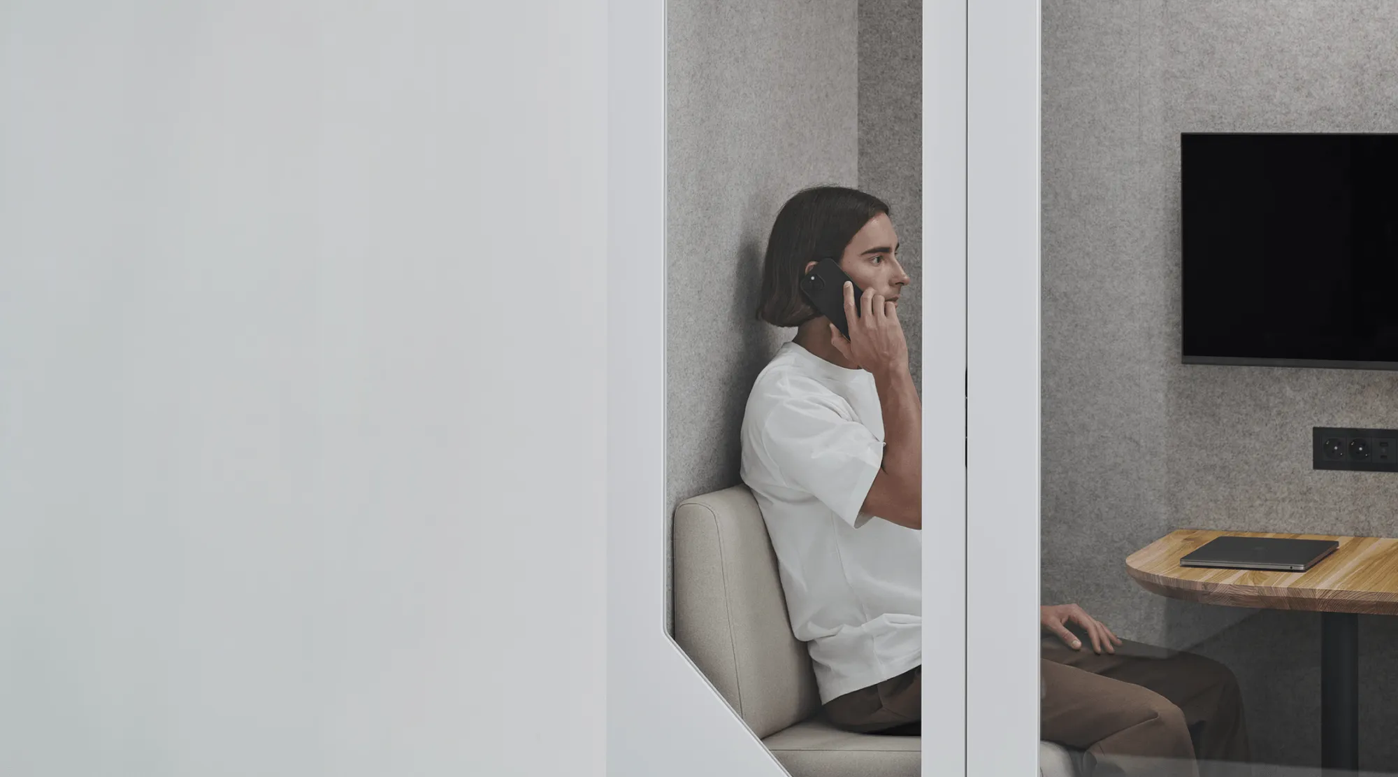 man talking in an office pod