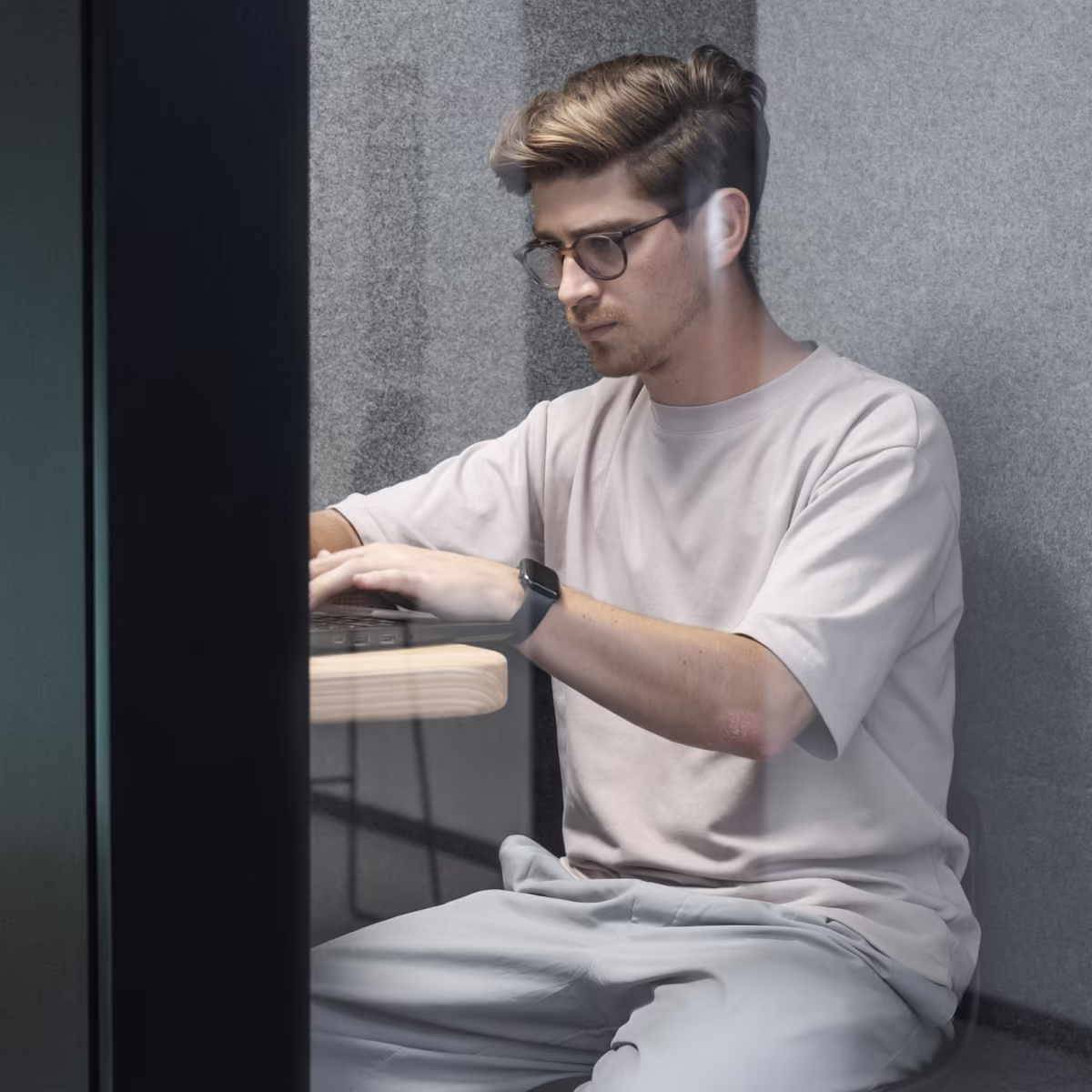 Person working quietly inside a soundproof office phone booth