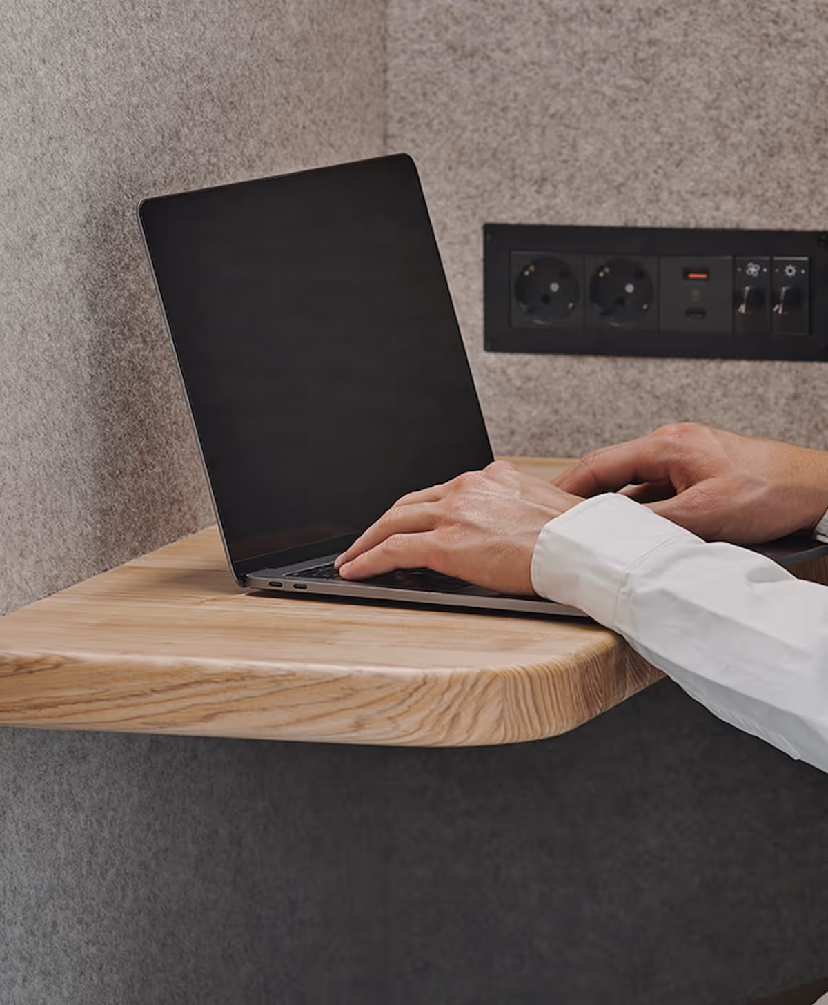 Office pod workspace with desk and built-in power outlets
