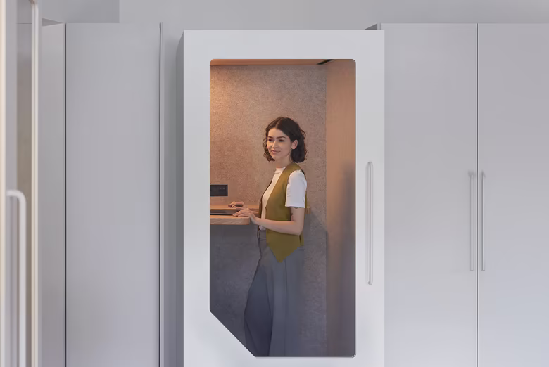 Persy phone booth interior showing a person working comfortably inside a soundproof office booth