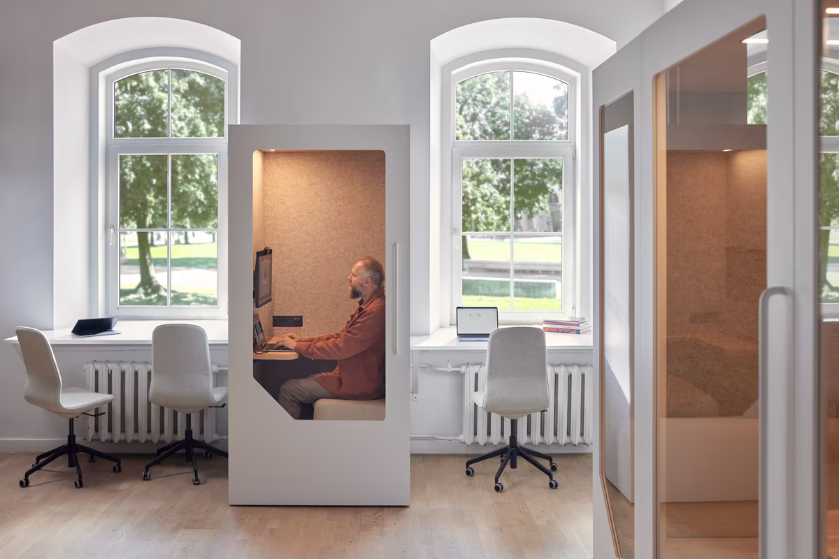 Employee working quietly inside an acoustic focus pod designed for concentrated work