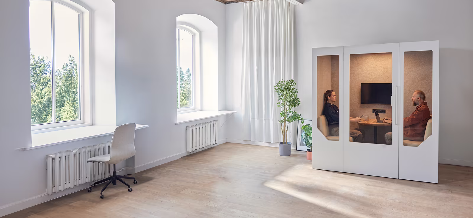 Soundproof office pods in an open workspace for distraction-free work