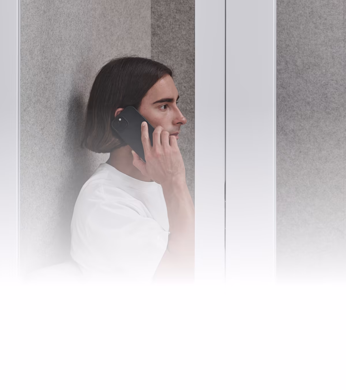 Person making a phone call inside a Persy soundproof booth with acoustic waveform comparison showing noise reduction