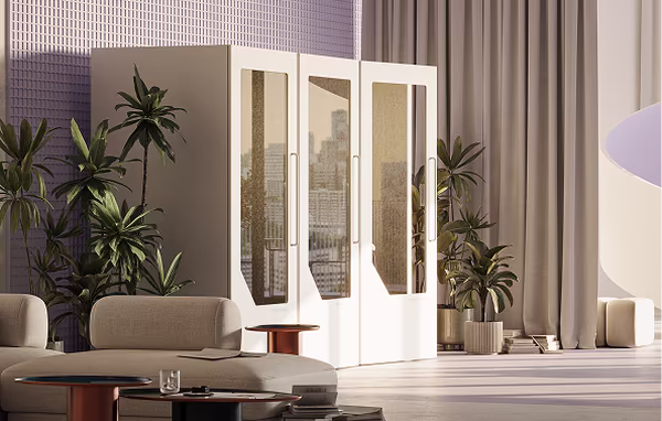 Persy booths integrated into a coworking space alongside existing furniture and plants