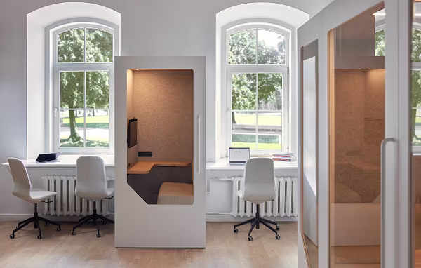 Persy booth positioned near arched windows in a bright office space