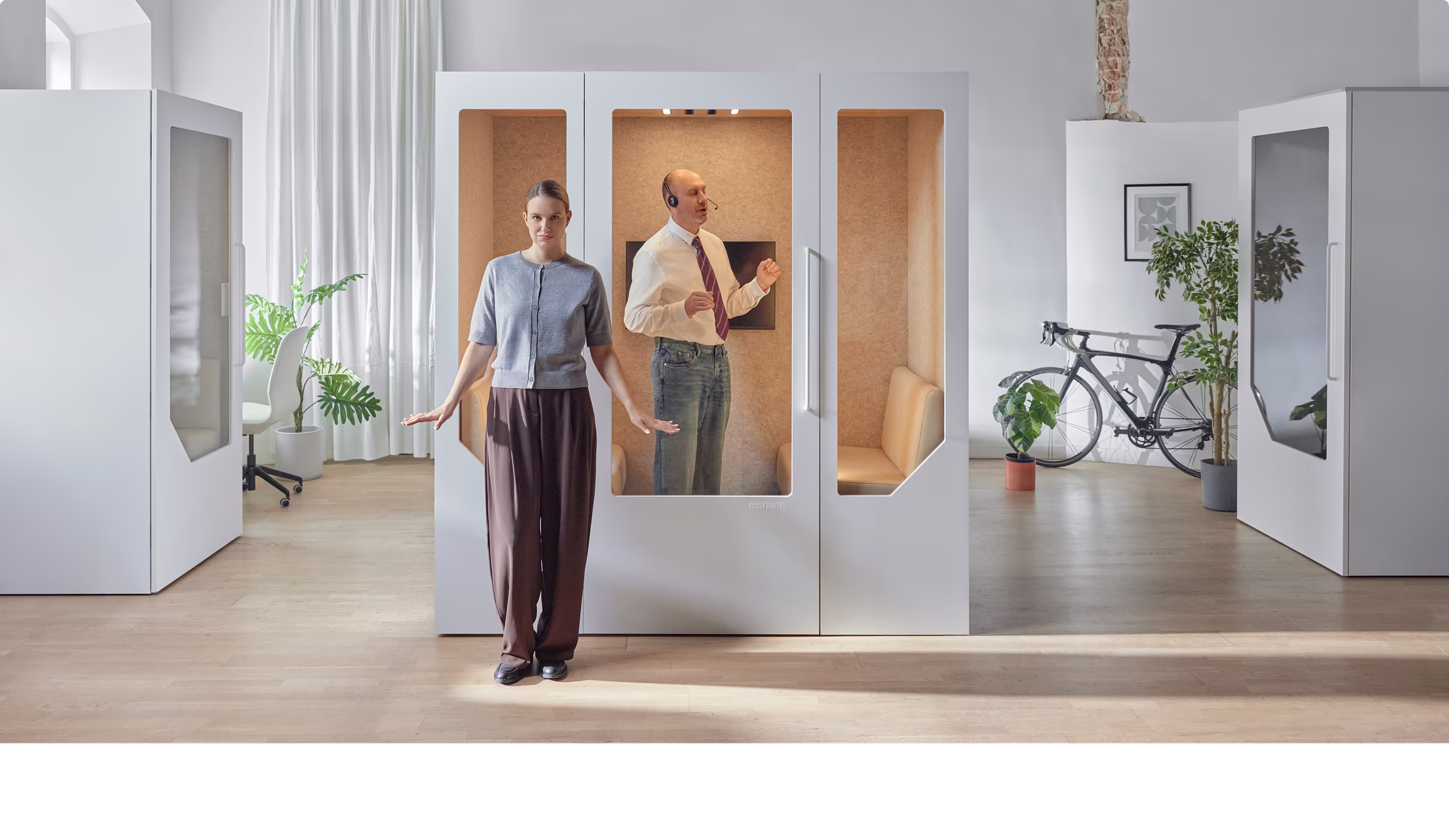 Professionals using Persy Booths soundproof office pods for private calls and meetings in a modern workspace.