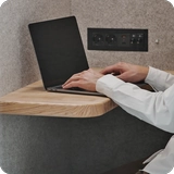 Hardwood table inside Persy Booth providing workspace for laptop and essentials