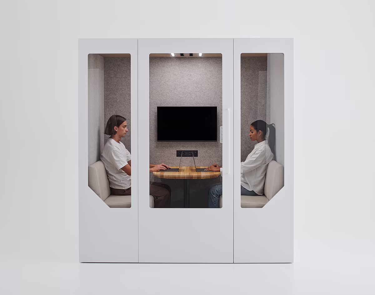 Students using a private meeting booth on a university campus