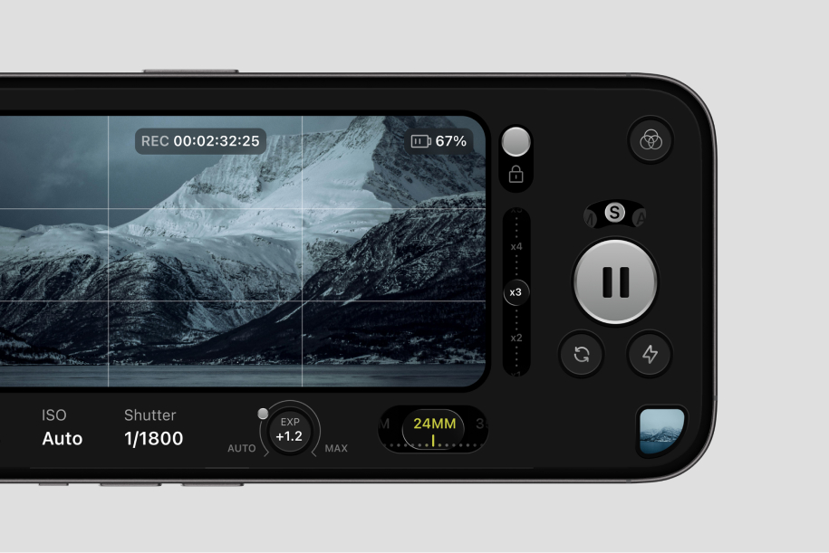 Close-up of a camera screen showing snowy mountain landscape with recording and settings info.