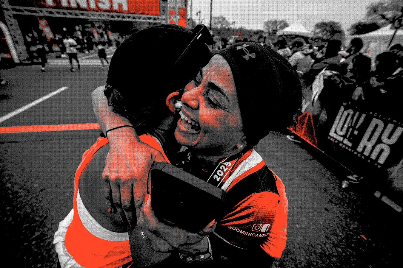 2 Women hugging celebrating finishing a running race with a black and orange pixilated effect | Make it Personal