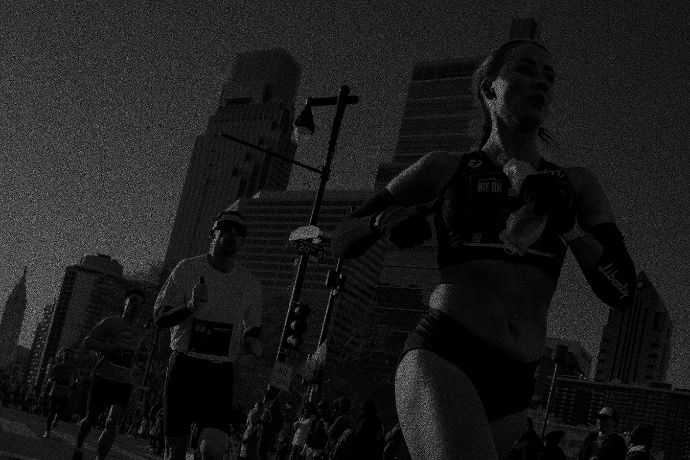 2 Women hugging celebrating finishing a running race with a black and orange pixilated effect | Make it Personal