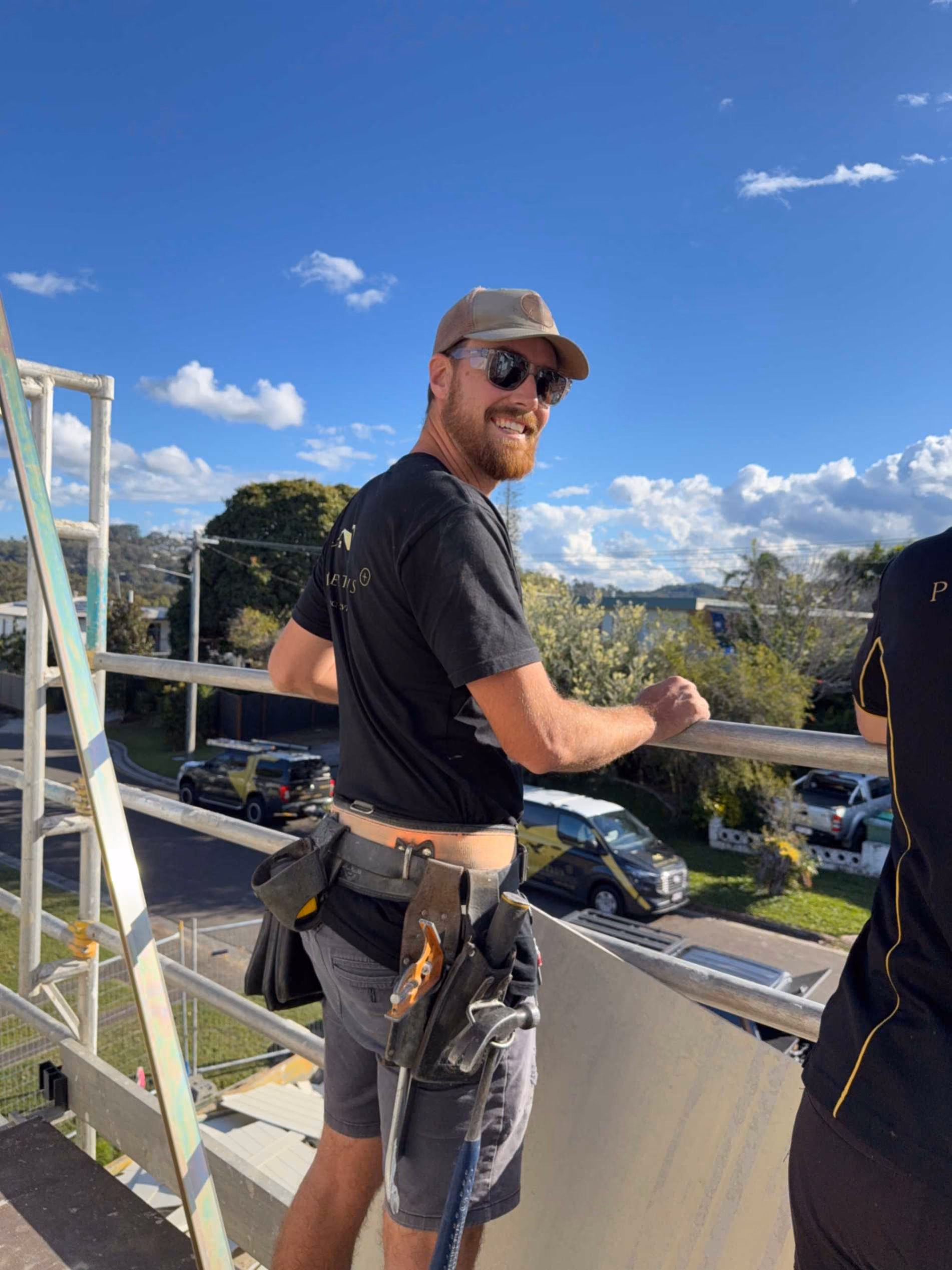 Carpenter in a hard hat at a timber-framed build
