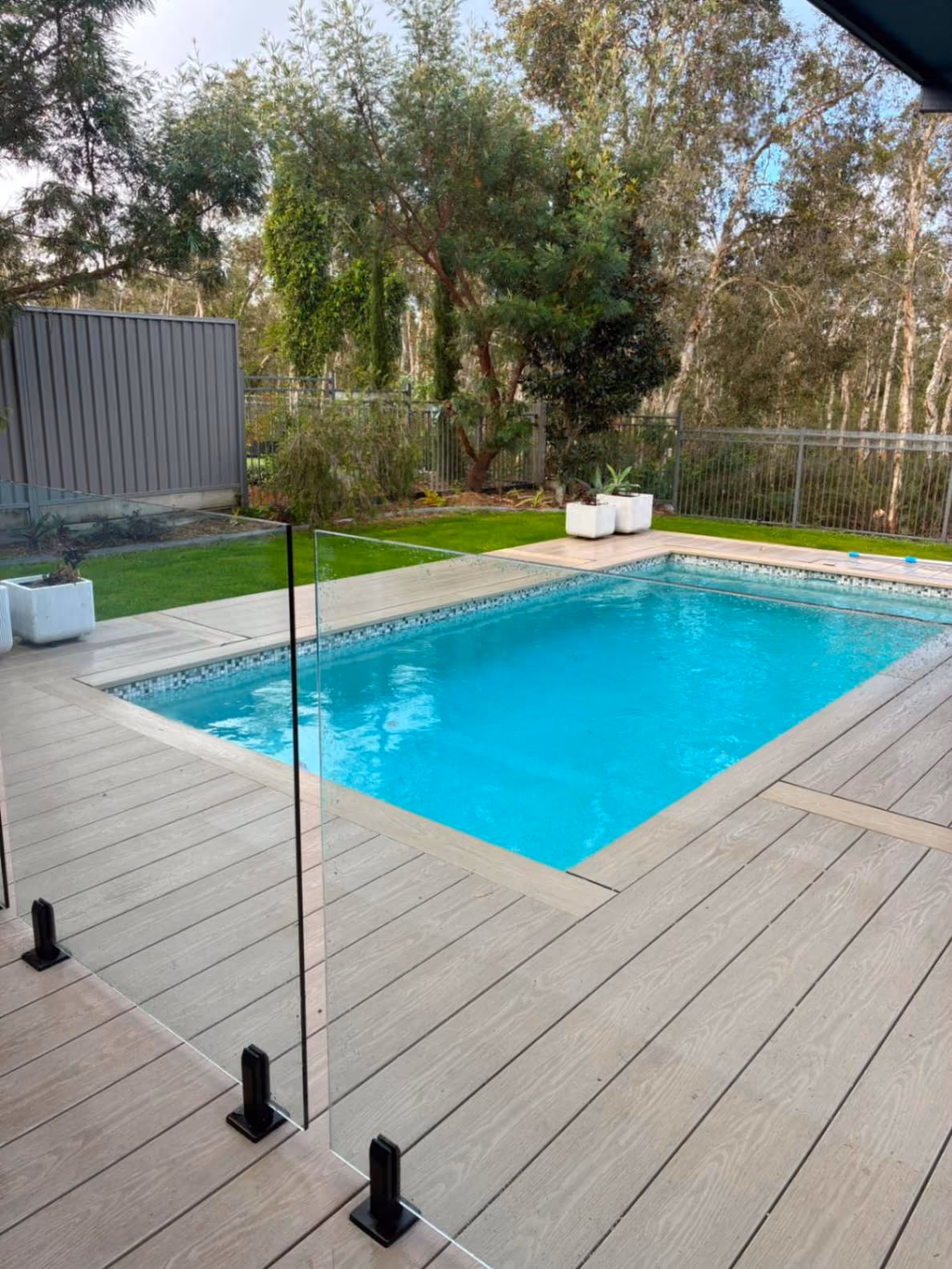 Timber boundary fence along a lawn