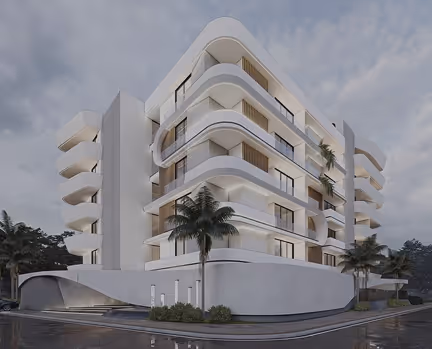 Modern white curved multi-story building with balconies and palm trees at dusk.