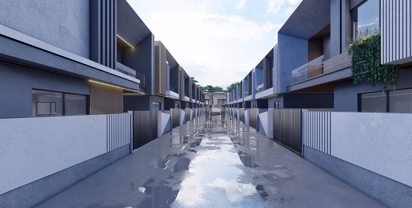 Modern townhouses with blue-gray facades lining a wet reflective concrete pathway.