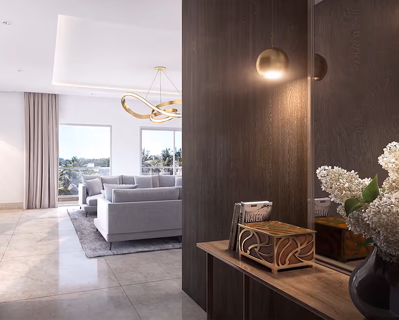Modern living room with grey sofas, gold chandelier, large windows, dark wood panel, and floral vase.
