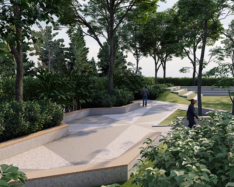 Park walkway with trees, bushes, and two people walking near tiered seating.