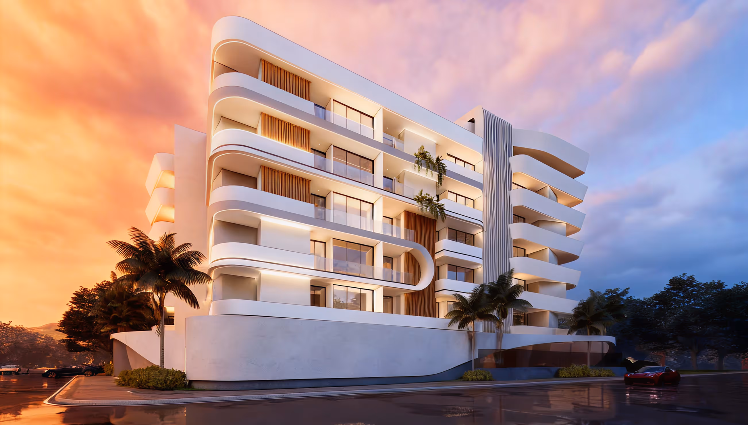 Modern white apartment building with curved balconies and palm trees at sunset.
