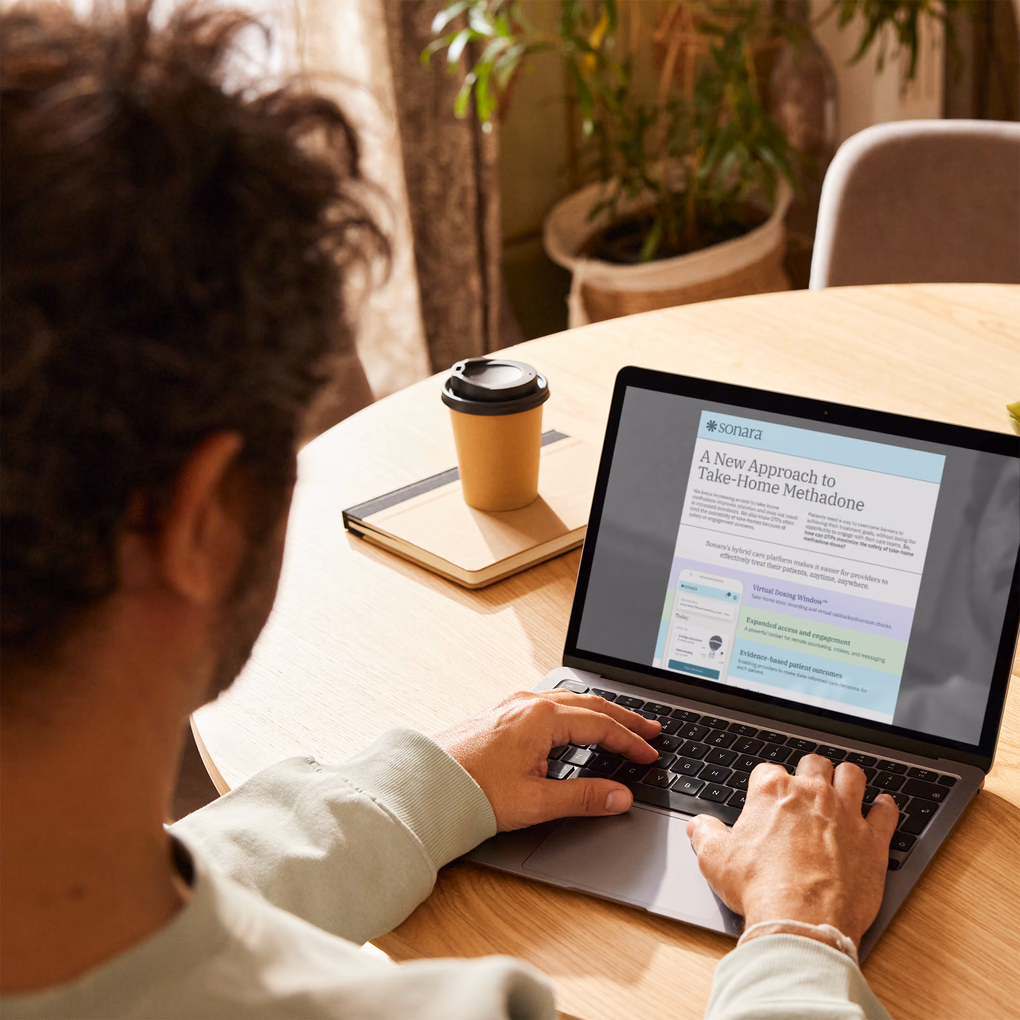 Person on laptop displaying article on a new approach to take-home methadone.