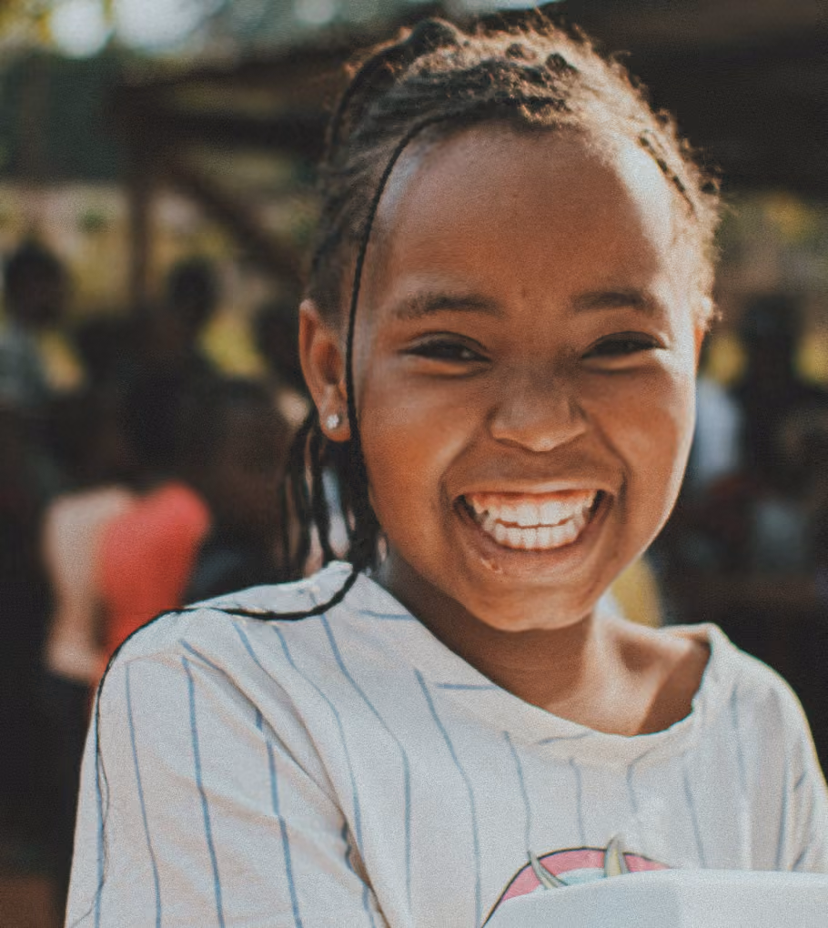 A girl smiles at the camera