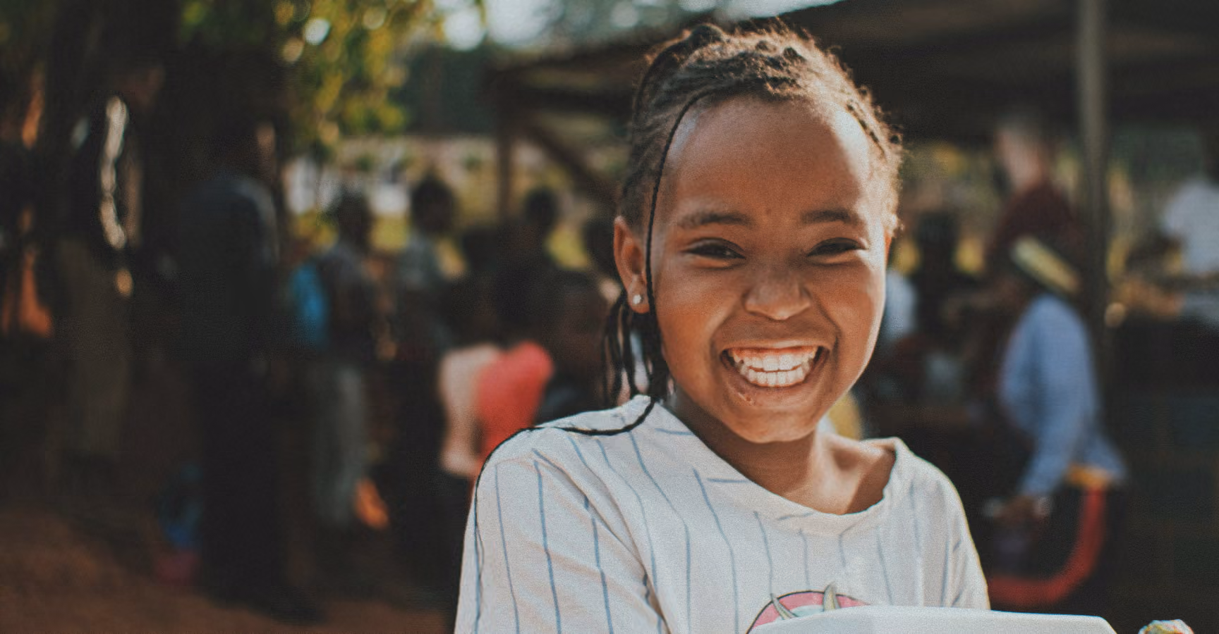 A young girl smiles at the camera