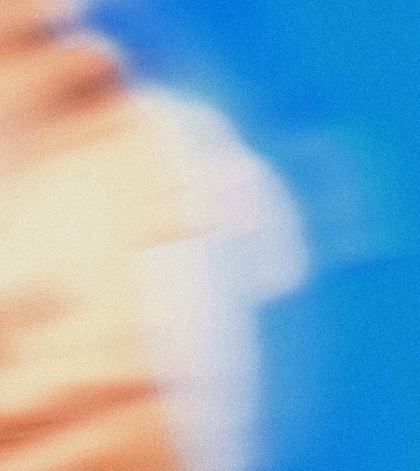 a blurred face on a blue background