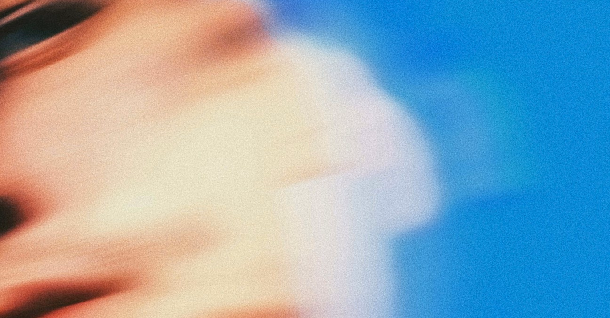 a blurred face on a blue background