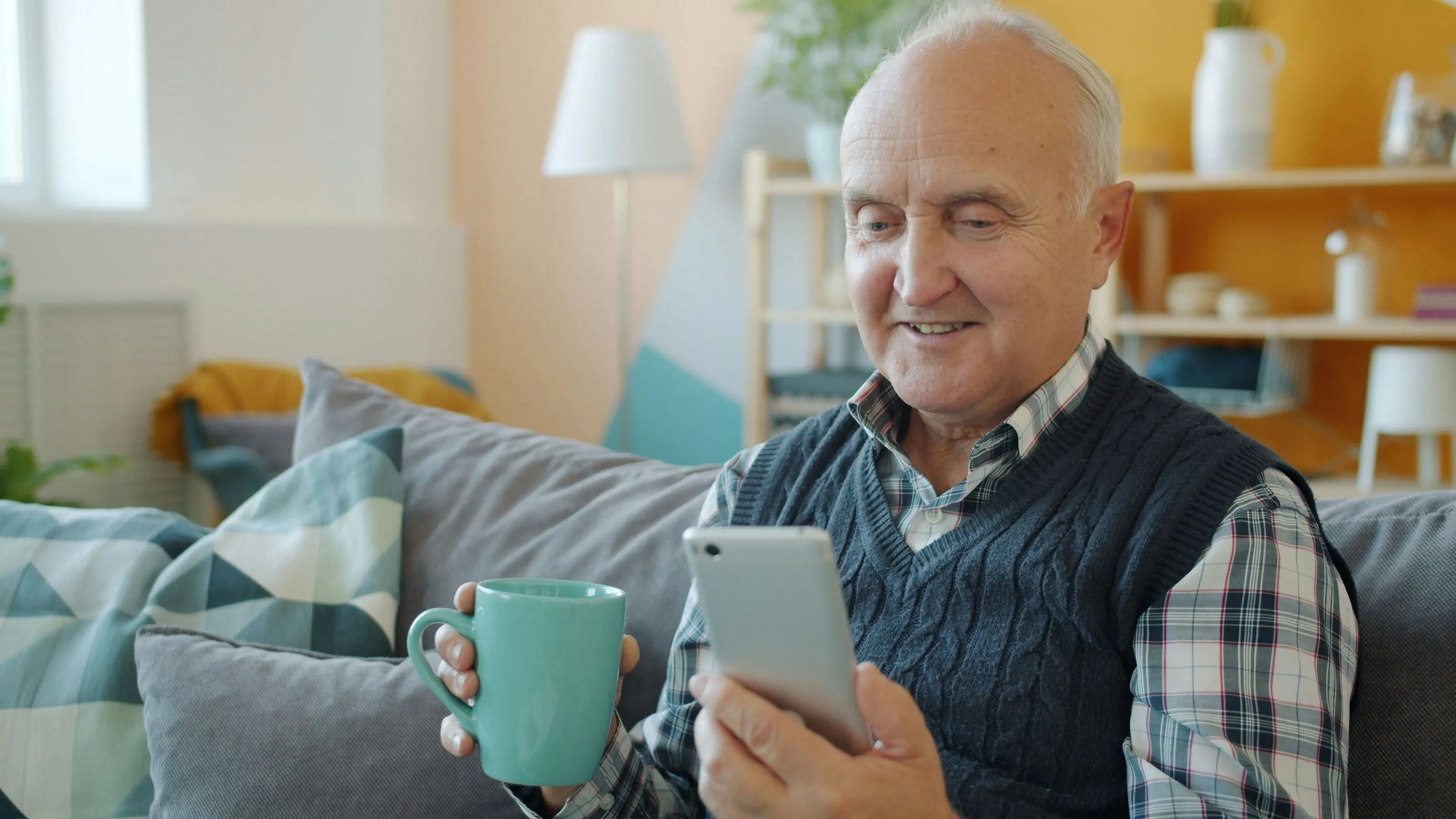 Older man using a phone while looking for financial support
