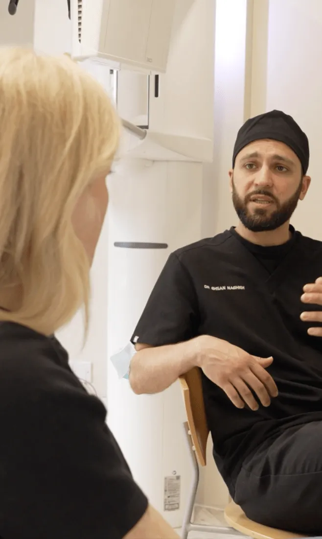 Dr Ehsan Naghieh talking with a patient during a consultation at Harley Private