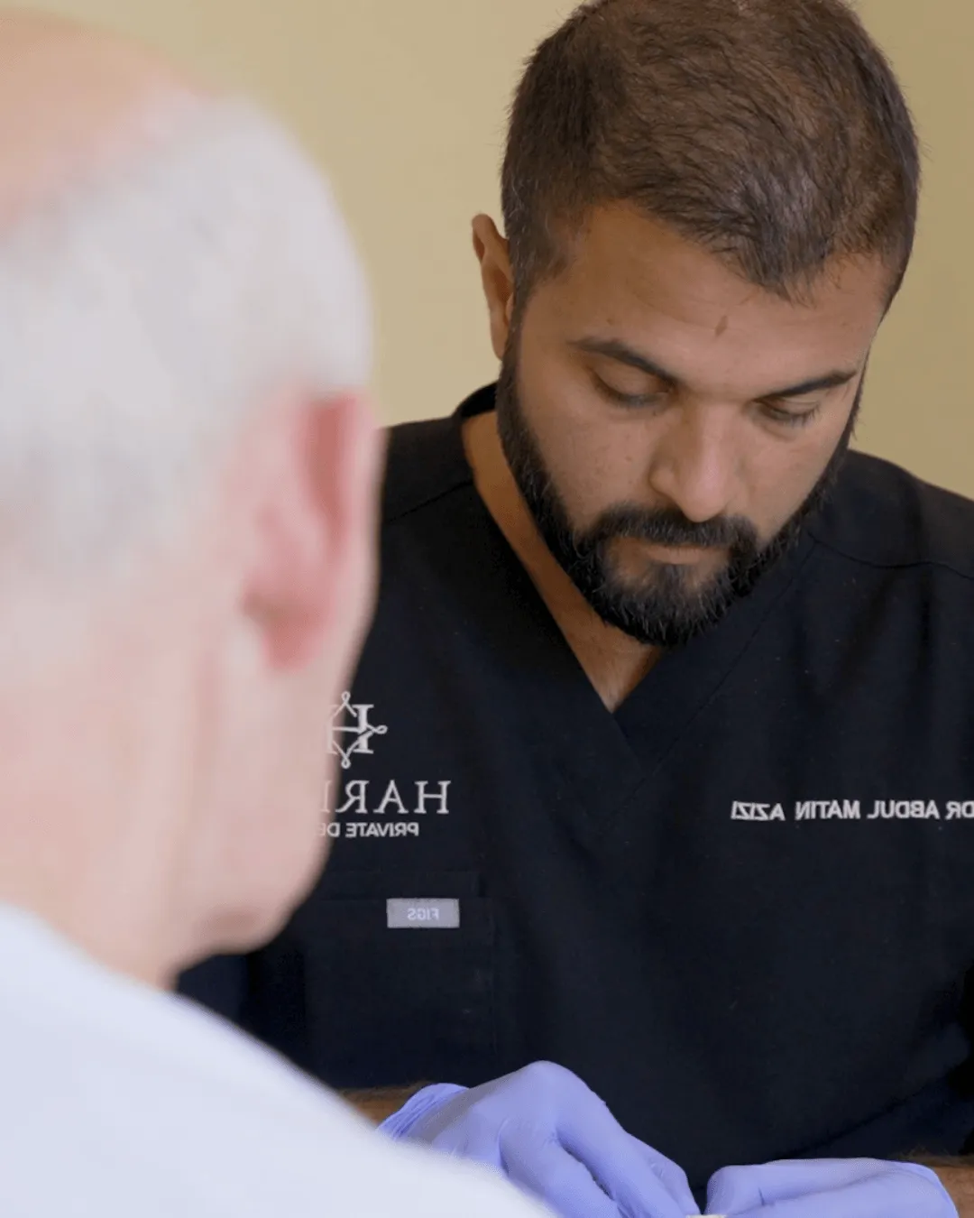 Dr Azizi working on a restoration beside a patient