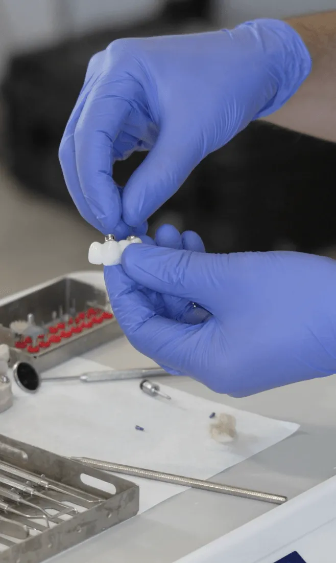 Harley Private clinician holding a dental bridge restoration